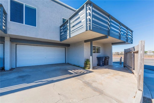 view of front facade featuring a balcony and a garage