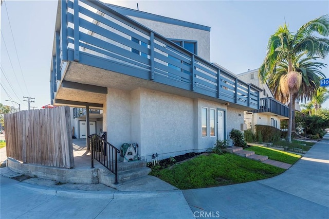 view of side of property with a balcony