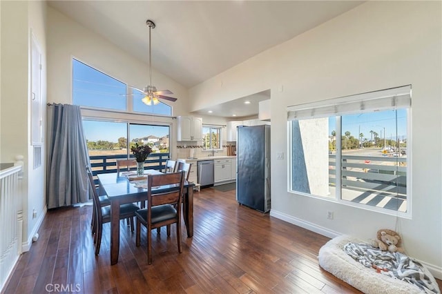 dining space with dark hardwood / wood-style floors, high vaulted ceiling, ceiling fan, and sink