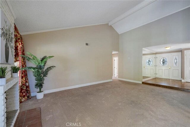 entryway featuring carpet floors, ornamental molding, and vaulted ceiling with beams