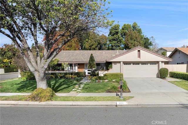 ranch-style home featuring a garage and a front lawn