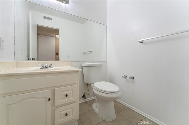 bathroom featuring tile patterned floors, vanity, and toilet