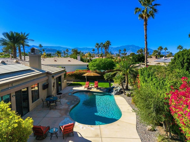 view of pool featuring a mountain view and a patio