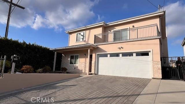 view of front facade with a garage and a balcony