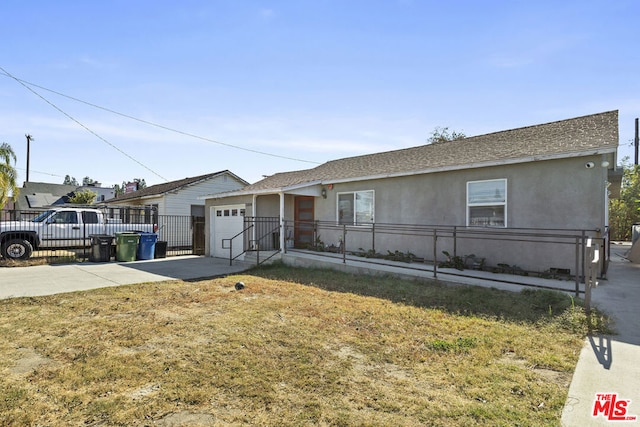 ranch-style home featuring a front yard and a garage