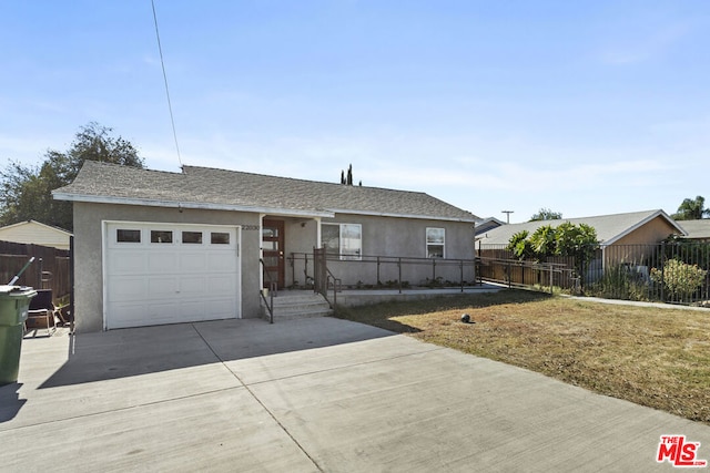 ranch-style house featuring a front yard and a garage