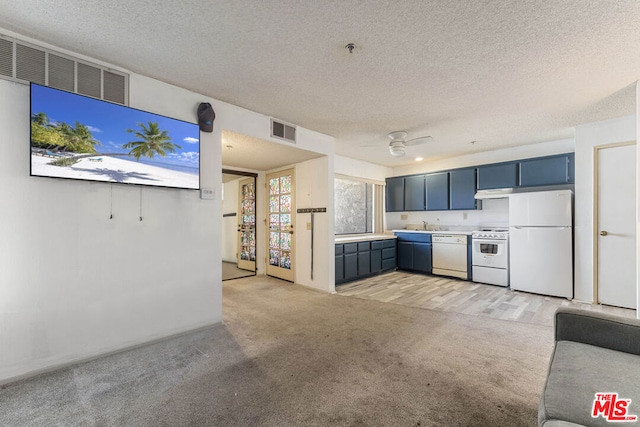 kitchen featuring a textured ceiling, white appliances, light colored carpet, and blue cabinets