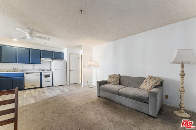 carpeted living room featuring ceiling fan, sink, and a textured ceiling