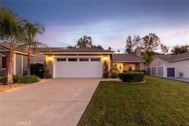 ranch-style house with a yard and a garage