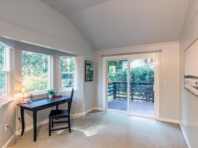 carpeted office with plenty of natural light and vaulted ceiling