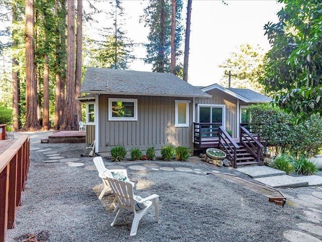 back of property featuring a wooden deck