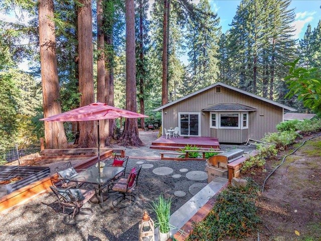 view of patio / terrace with a wooden deck, a grill, and exterior kitchen