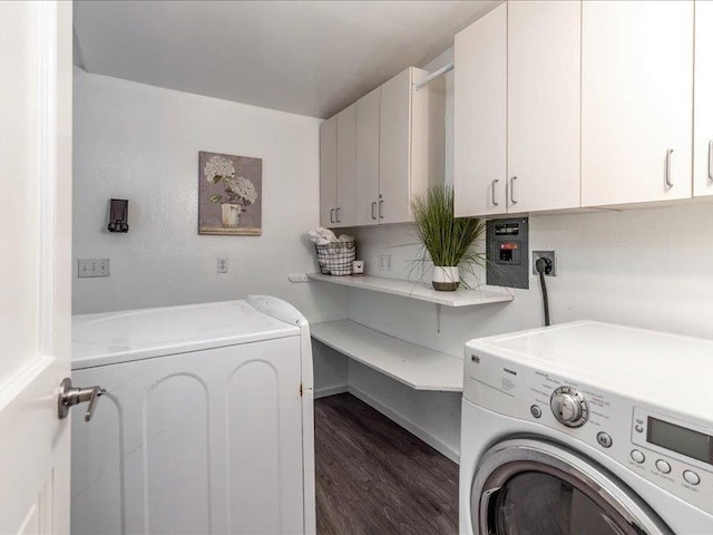 laundry area featuring cabinets, washing machine and dryer, and dark wood-type flooring