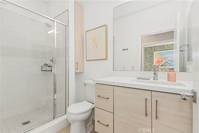 bathroom with tile patterned flooring, vanity, toilet, and walk in shower