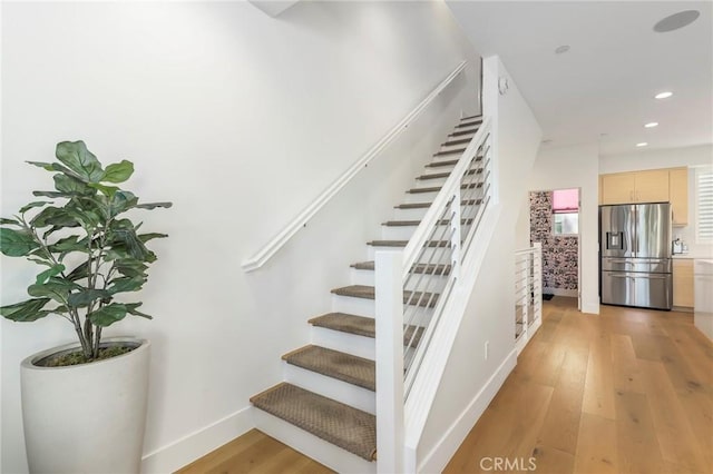 staircase with hardwood / wood-style flooring