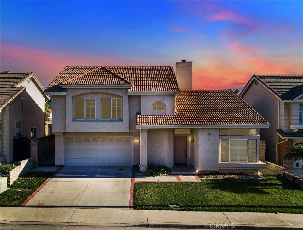 view of front of home with a lawn and a garage