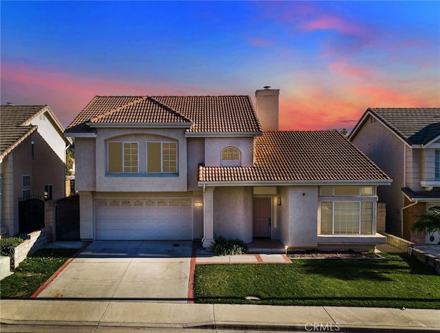 view of front of home with a lawn and a garage