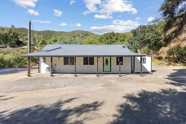 view of front of home featuring a mountain view and a porch