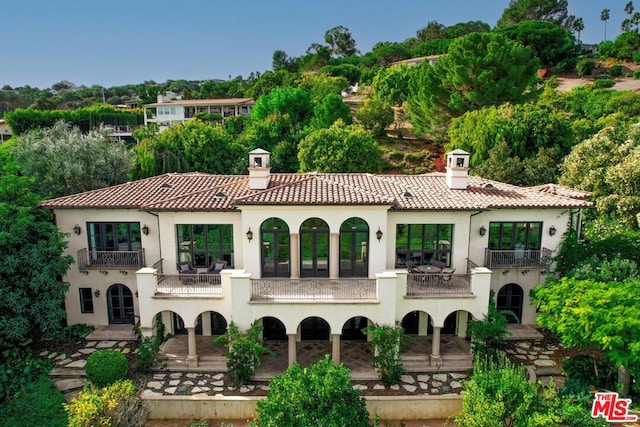 back of property featuring a balcony