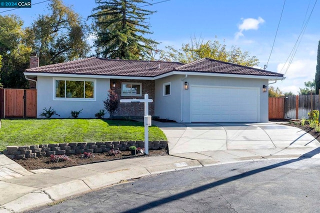 ranch-style house featuring a front lawn and a garage