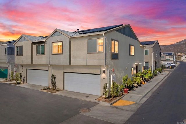 view of front facade with solar panels and a garage