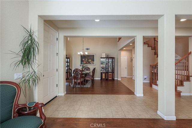 foyer entrance featuring an inviting chandelier and light wood-type flooring