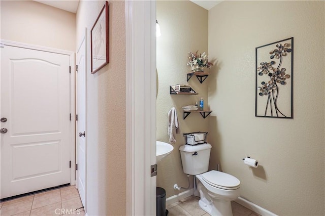 bathroom featuring tile patterned floors and toilet