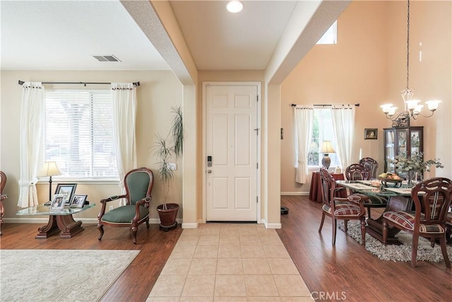 entrance foyer with a notable chandelier and light wood-type flooring