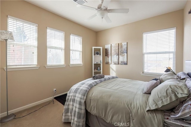 bedroom featuring multiple windows, carpet flooring, and ceiling fan