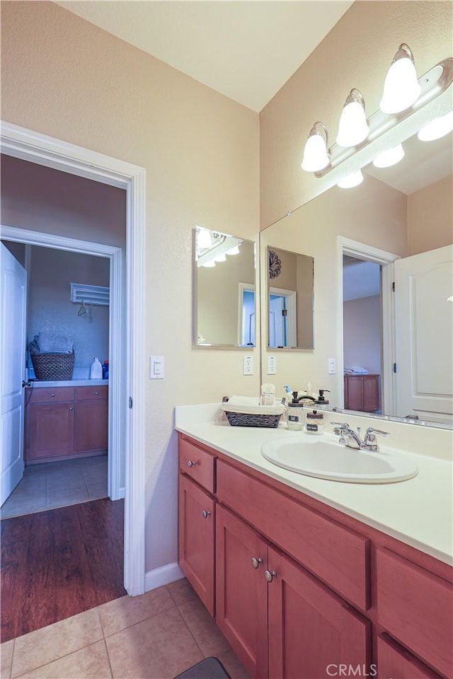 bathroom with tile patterned flooring and vanity