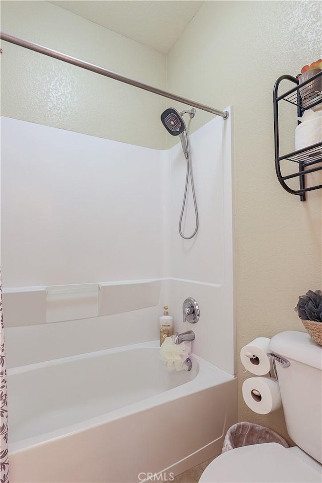 bathroom with toilet and shower / tub combo