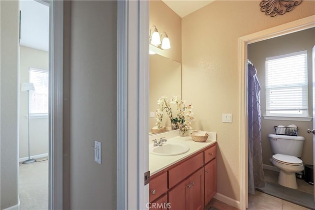 bathroom featuring tile patterned floors, vanity, and toilet