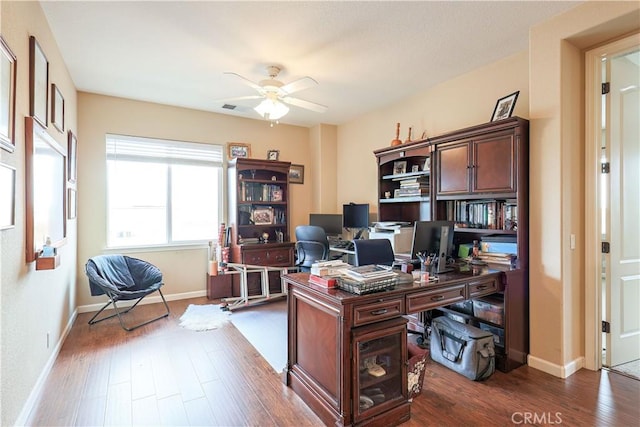 office space featuring dark wood-type flooring and ceiling fan