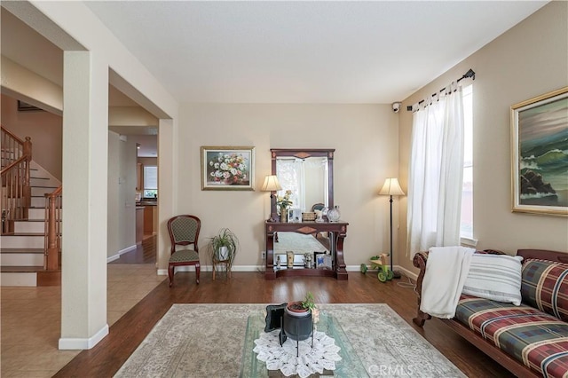 living room with dark wood-type flooring and plenty of natural light