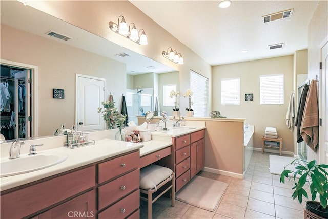 bathroom with independent shower and bath, vanity, and tile patterned floors