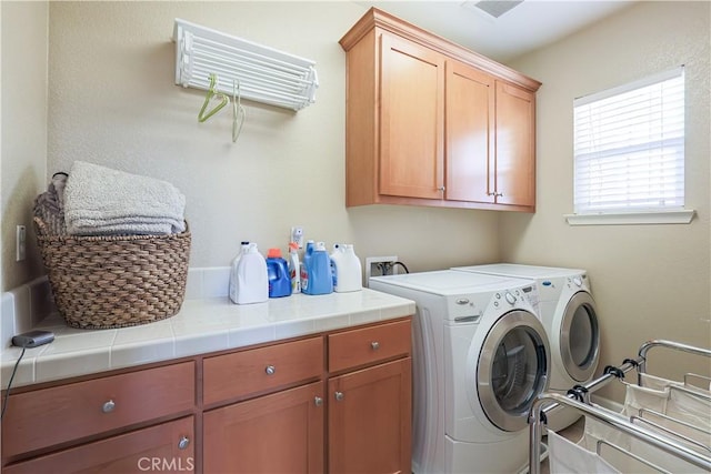 laundry area featuring cabinets and separate washer and dryer