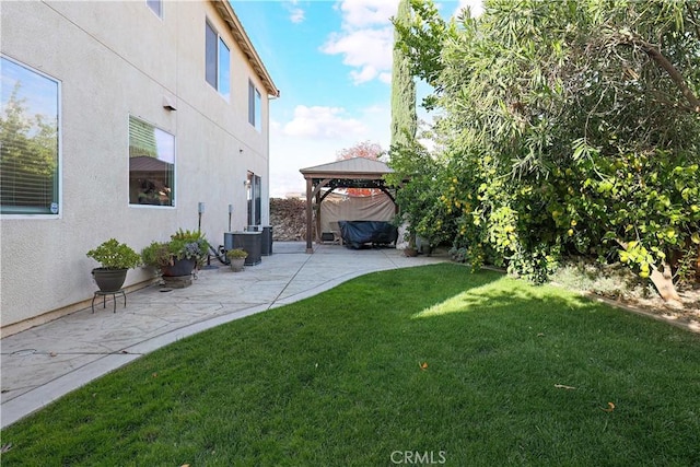 view of yard with a gazebo, central AC, and a patio