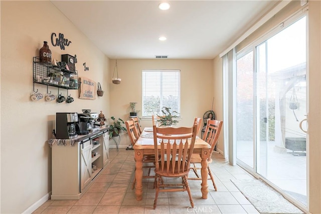 dining room featuring light tile patterned floors and plenty of natural light