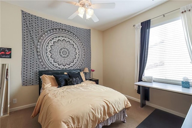 bedroom featuring multiple windows, light carpet, and ceiling fan