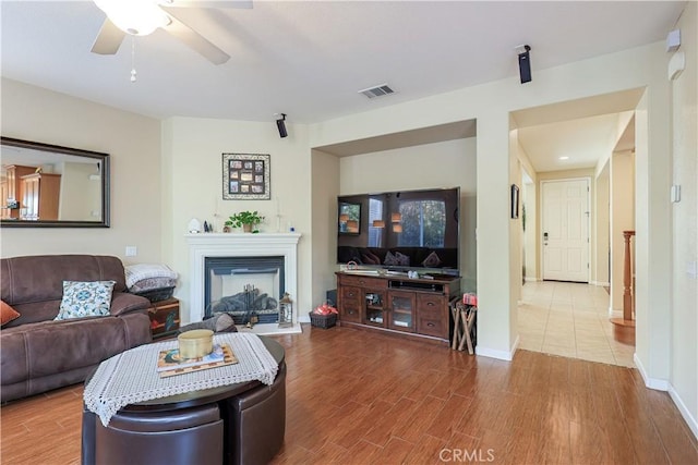 living room featuring hardwood / wood-style floors and ceiling fan