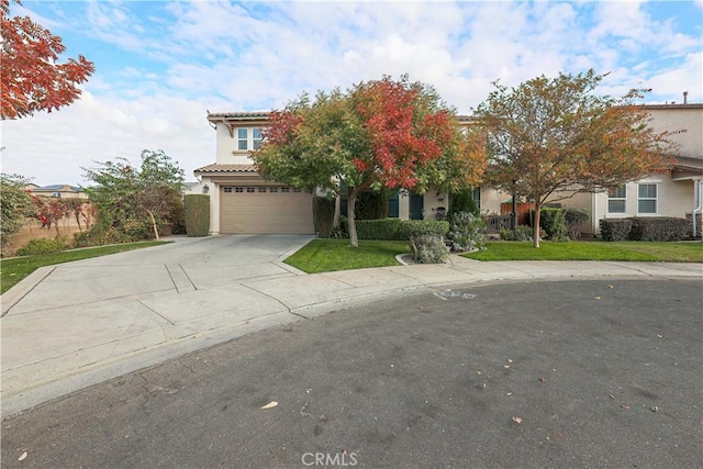 view of front of house with a garage and a front lawn