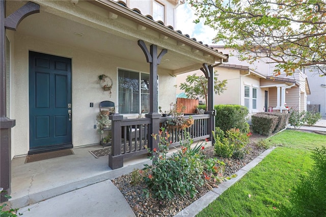 view of exterior entry with a porch