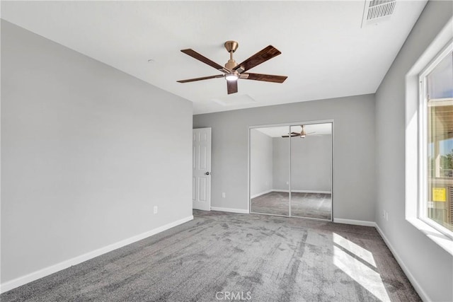 unfurnished bedroom with carpet flooring, ceiling fan, and a closet