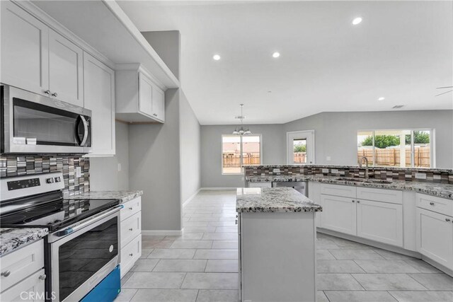 kitchen featuring sink, plenty of natural light, white cabinets, and appliances with stainless steel finishes