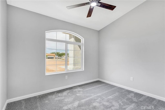 carpeted empty room featuring ceiling fan and lofted ceiling