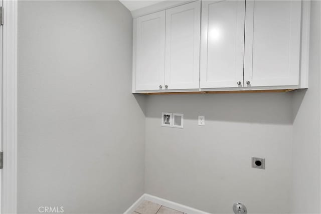 laundry area with hookup for an electric dryer, cabinets, light tile patterned floors, and hookup for a washing machine