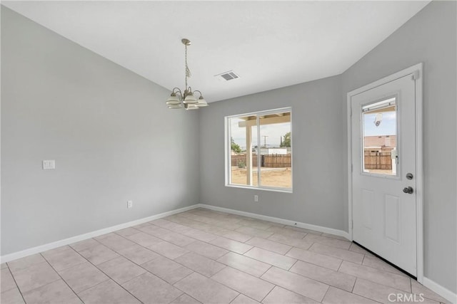 interior space featuring light tile patterned floors and an inviting chandelier