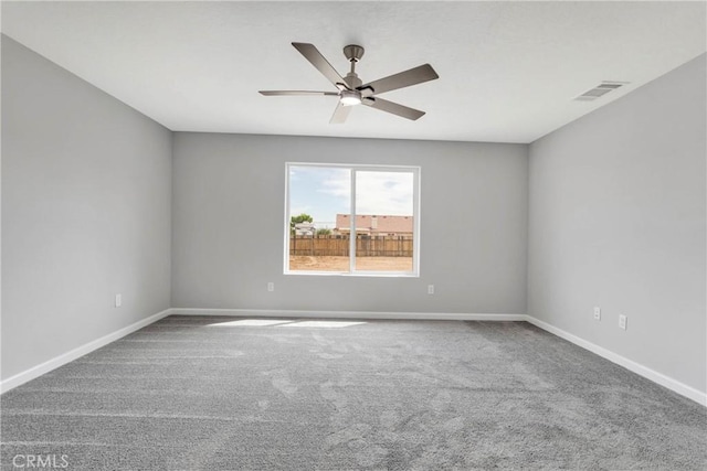 carpeted spare room featuring ceiling fan