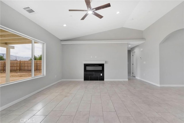 unfurnished living room with ceiling fan, light tile patterned floors, and vaulted ceiling