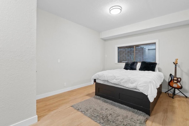 bedroom with hardwood / wood-style floors